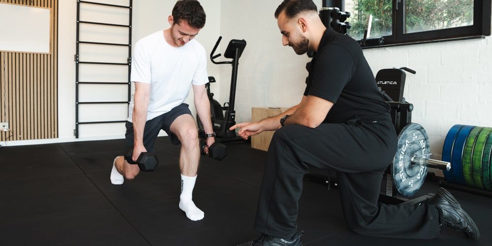 A supervised session in the practice's training room, working with dumbbells